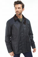 Men's navy wax jacket in 3/4 view with dark brown collar and flap pockets