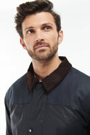 Men's navy wax jacket with dark brown collar and buttoned front placket