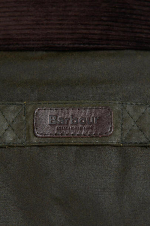 Barbour branded patch on olive wax jacket chest, stitched yoke and seam details