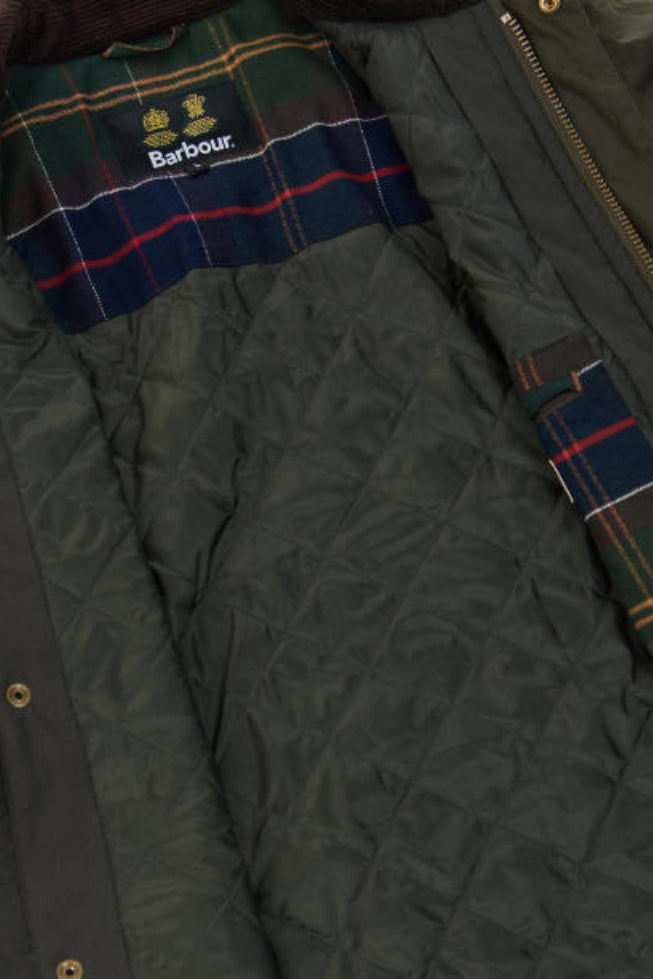 Olive wax jacket interior lining with Barbour label and plaid trim panel