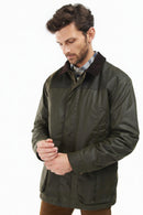 Barbour wax jacket in olive green, front view with zip front and chest flap pockets