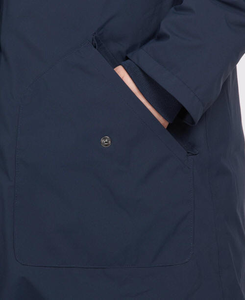 Navy waterproof jacket chest pocket with metal snap button and flap