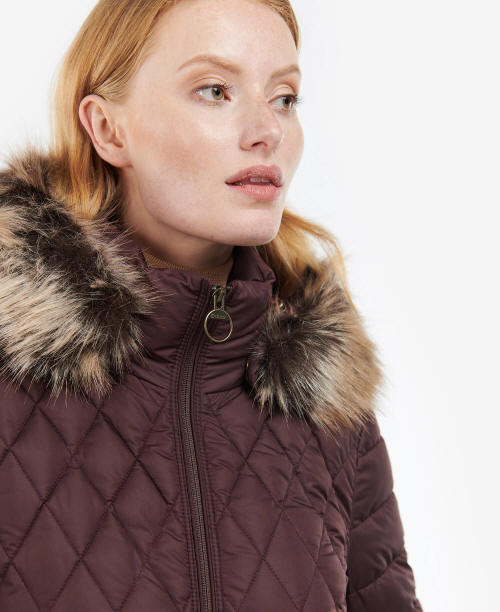 Faux fur-trimmed stand collar on dark maroon quilted jacket with front zipper