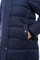 Navy quilted jacket front with gold-tone snaps and padded horizontal baffles