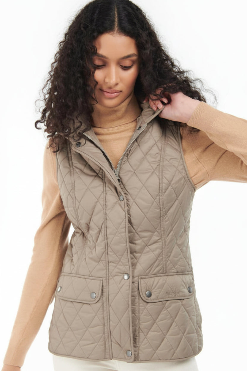 Quilted vest gilet in light tan with button front, stand collar, and snap flap pockets