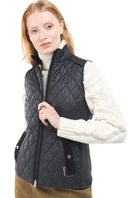 Black quilted gilet vest with zip front, diamond quilting, and front pocket tabs