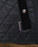 Black Barbour quilted gilet fabric detail with diamond quilting and logo patch