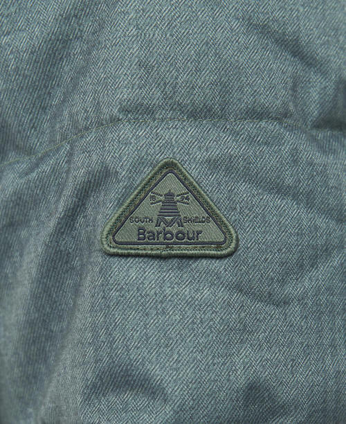Dark green quilted coat with triangular Barbour logo patch
