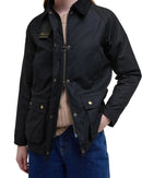 Black women’s wax jacket with zip front, stand collar, and buttoned flap pockets