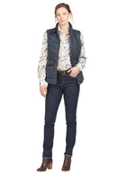 Navy quilted sleeveless gilet with full zip, stand collar, and front utility pockets.